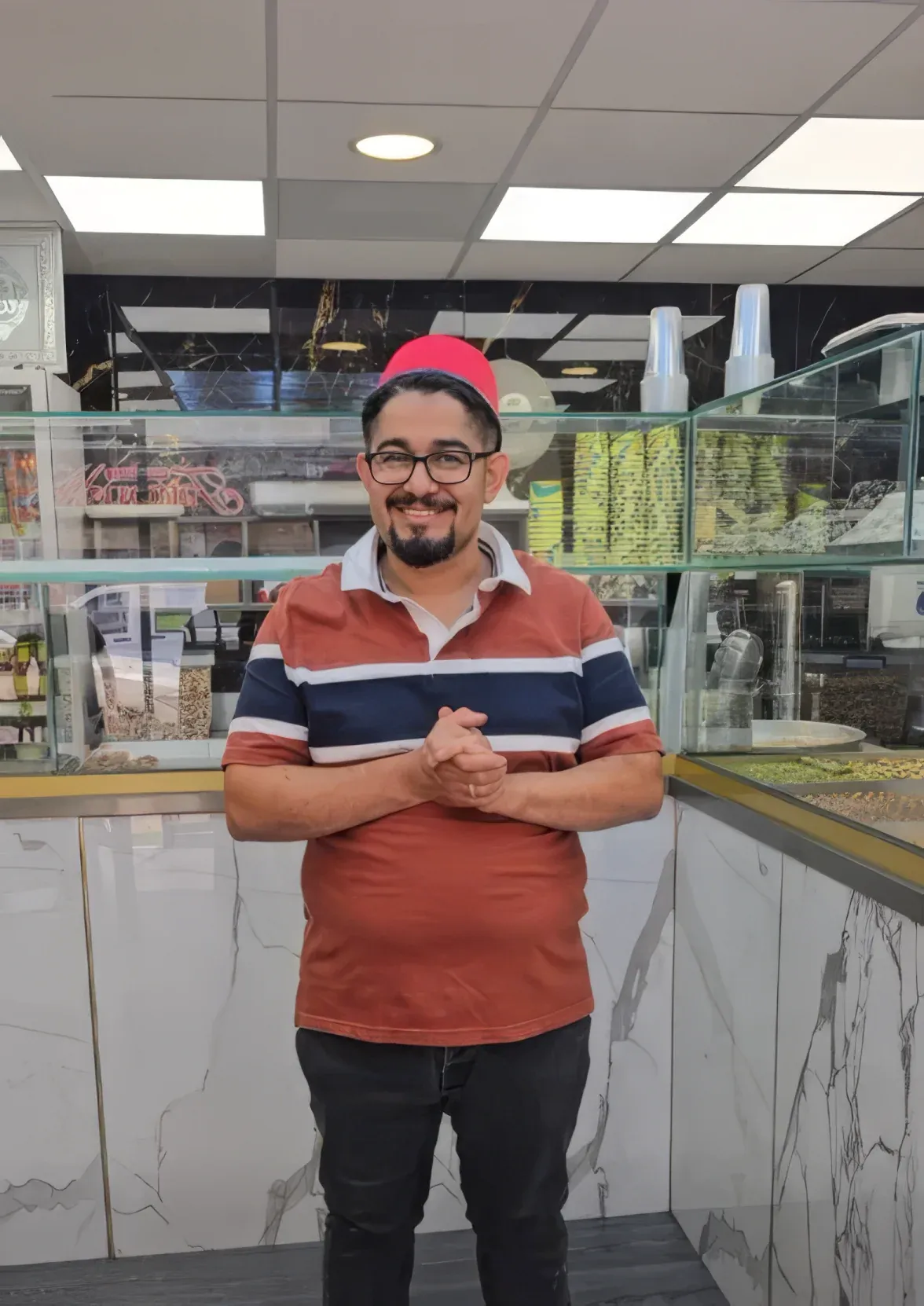 The owner standing proudly in the King of Sweets shop in Newcastle